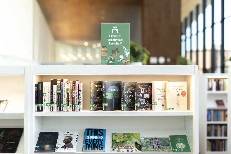Eco shelf, a curated shelf of books on environmental sustainability in a library. The books are marked with green stickers.